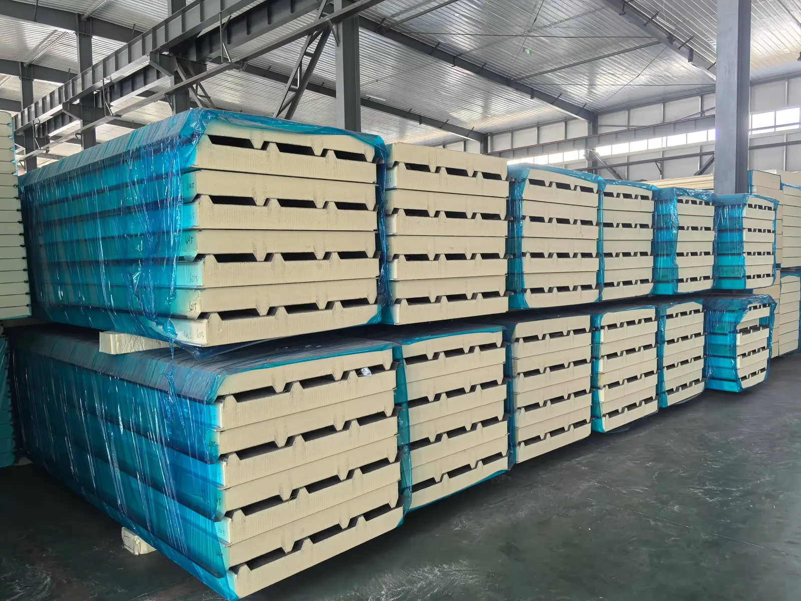 Sandwich panel with blue protective film in factory