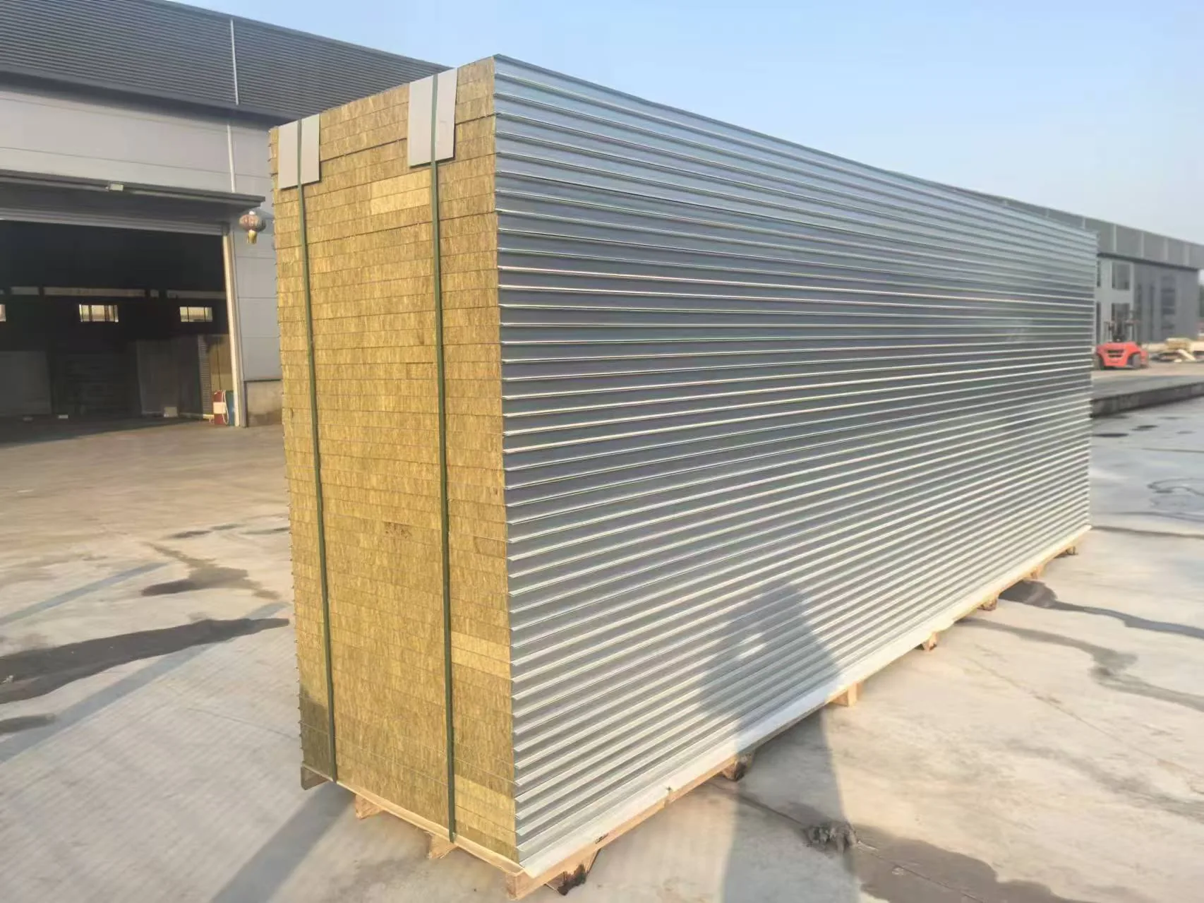 Rock wool sandwich panel bundle staged in factory yard