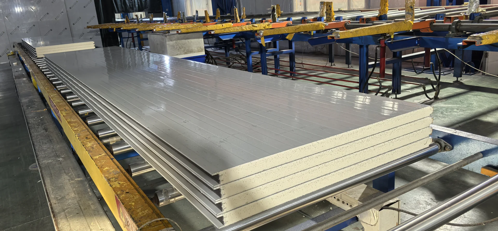 Sandwich panel lamination line in operation producing insulated panels